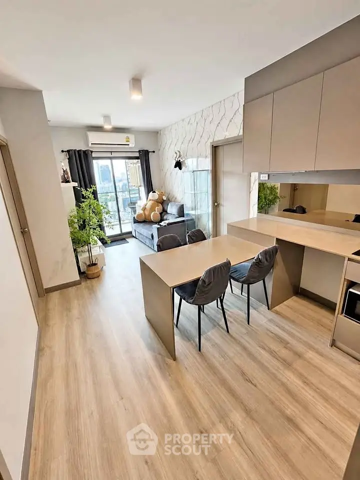 Modern open-plan living room with stylish decor and balcony view