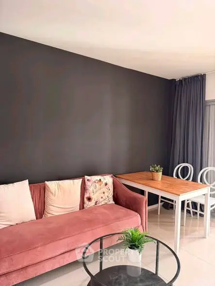 Stylish living room with pink sofa, modern table, and elegant decor