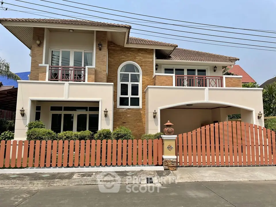 Stunning two-story house with elegant facade and charming fenced yard in a serene neighborhood.
