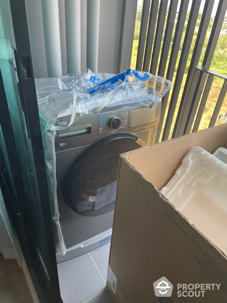 Modern apartment balcony with new washing machine installation