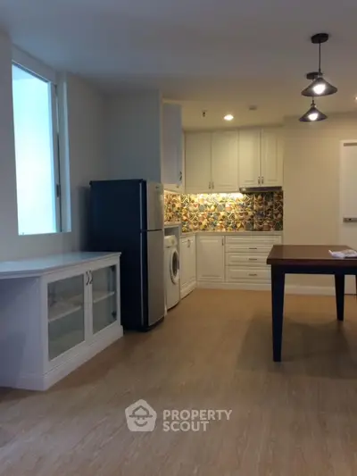 Charming kitchen with modern appliances and stylish backsplash in cozy apartment