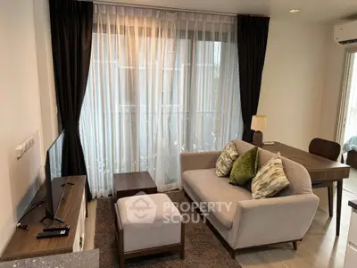Cozy living room with modern furniture and large window for natural light