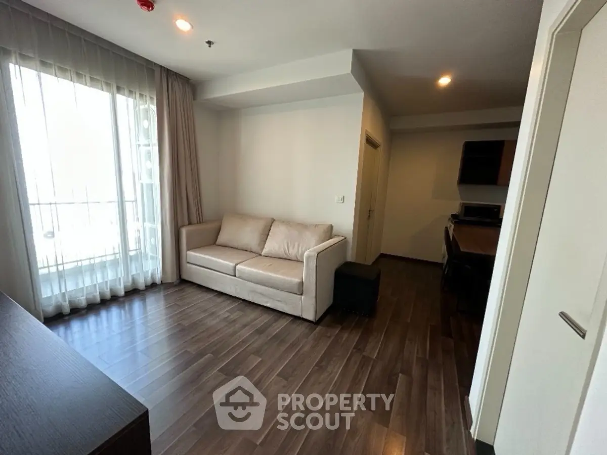 Modern living room with wooden flooring and natural light