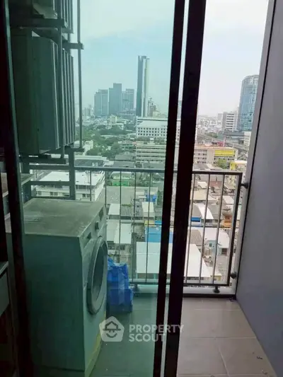 High-rise balcony with city view and washing machine, perfect for urban living.