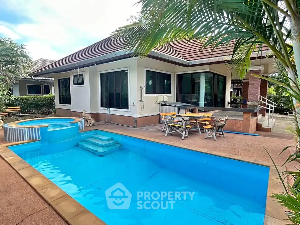 Luxurious villa with private pool and outdoor seating area, perfect for relaxation.