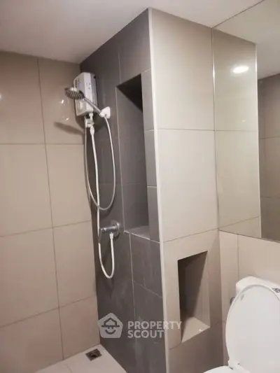 Modern bathroom with sleek tiles and built-in shower unit