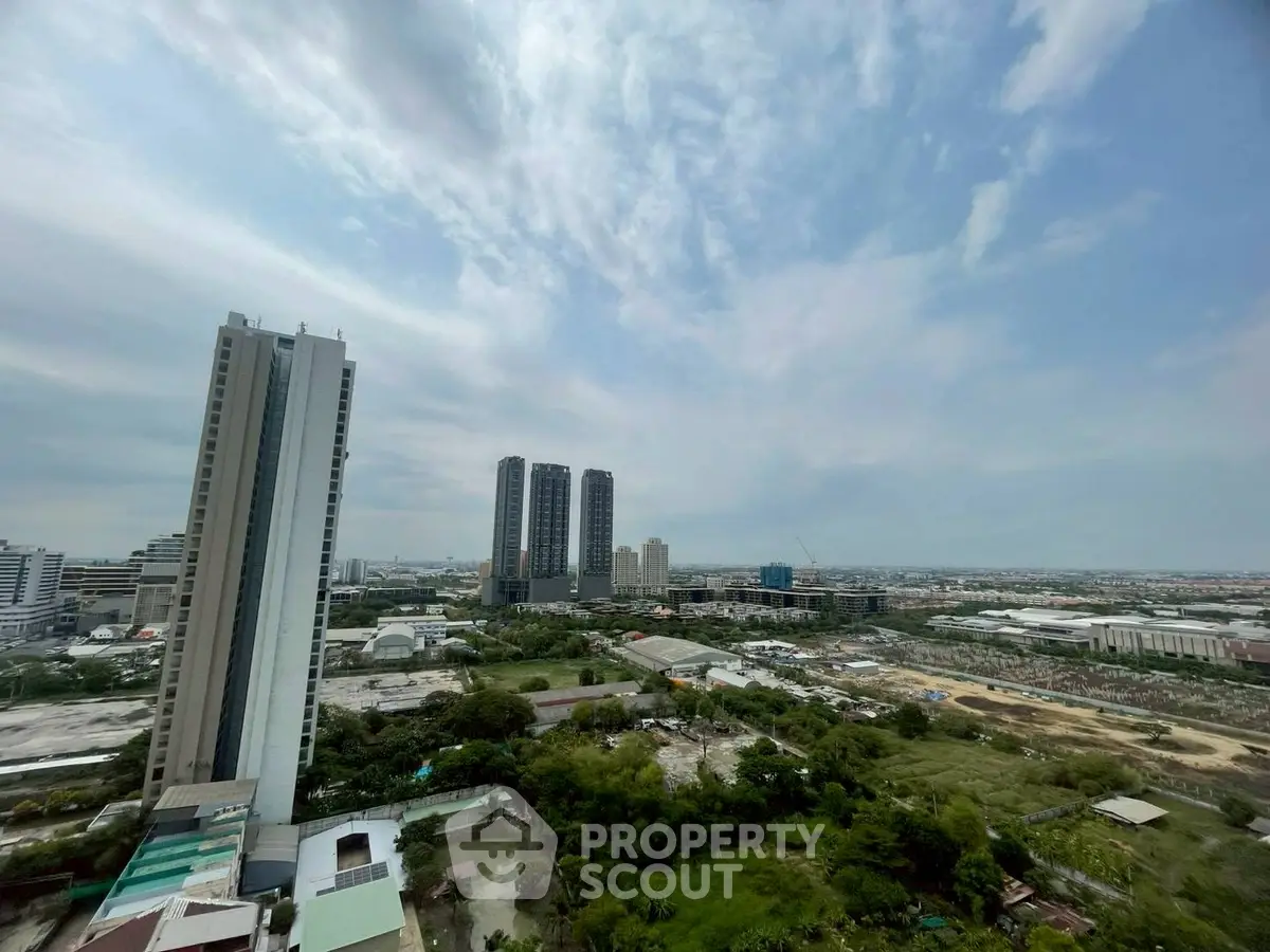 Stunning cityscape view from high-rise building showcasing urban skyline and lush greenery.