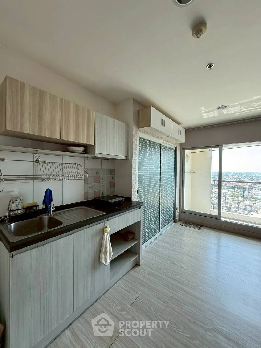 Modern kitchen with open layout and stunning city view from balcony