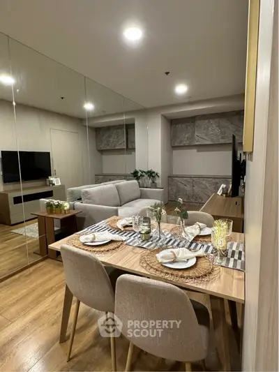 Modern living room with elegant dining area, stylish decor, and cozy ambiance