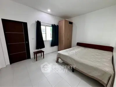 Spacious bedroom with modern furnishings and natural light