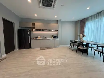 Spacious modern kitchen with dining area and sleek appliances