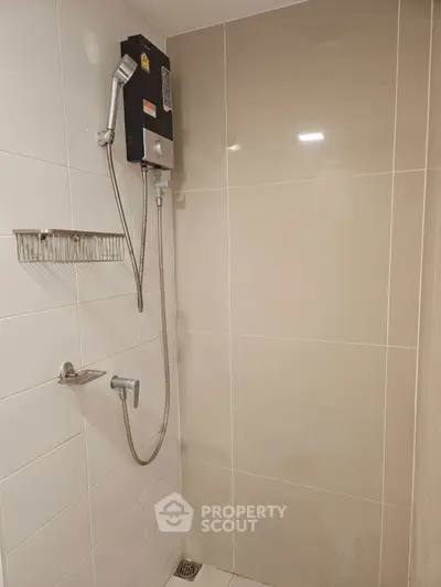 Modern bathroom shower area with sleek tiles and water heater