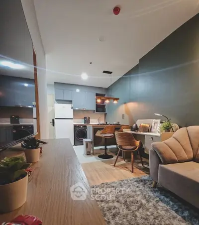 Modern living room with open kitchen, stylish furniture, and cozy lighting