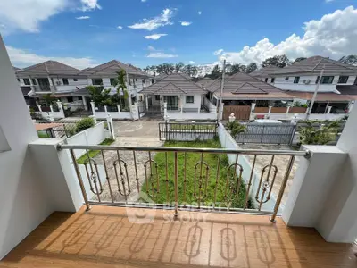 Charming balcony view of suburban neighborhood with clear blue skies.