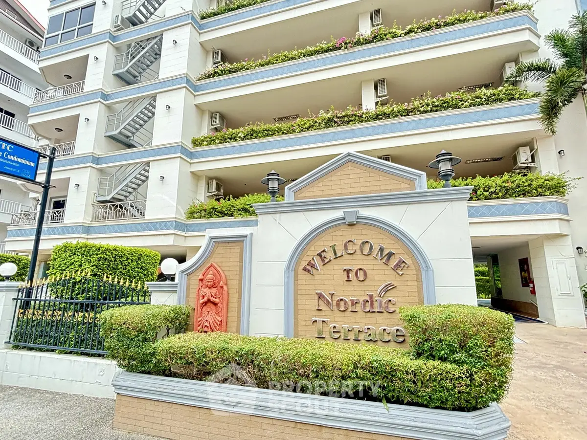 Charming Nordic Terrace building with lush greenery and welcoming entrance.