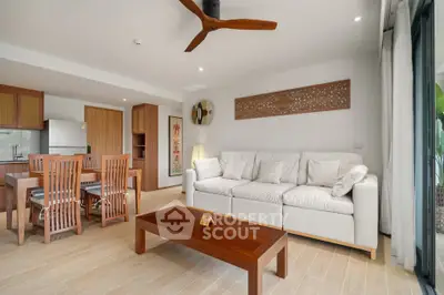 Spacious living room with modern decor and open kitchen layout, perfect for entertaining.