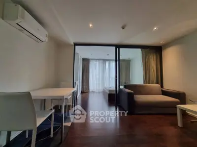 Modern living room with sleek furniture and large windows for natural light.