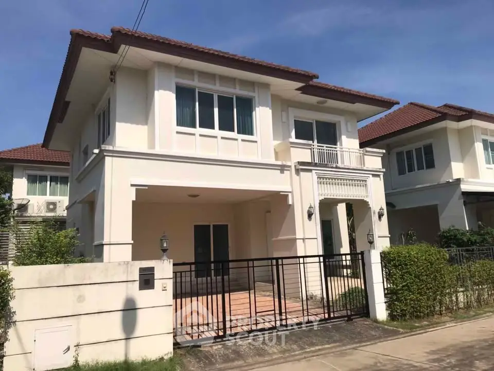 Elegant two-story house with modern design and spacious driveway in a serene neighborhood.
