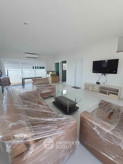 Spacious living room with modern furniture and large windows for natural light.