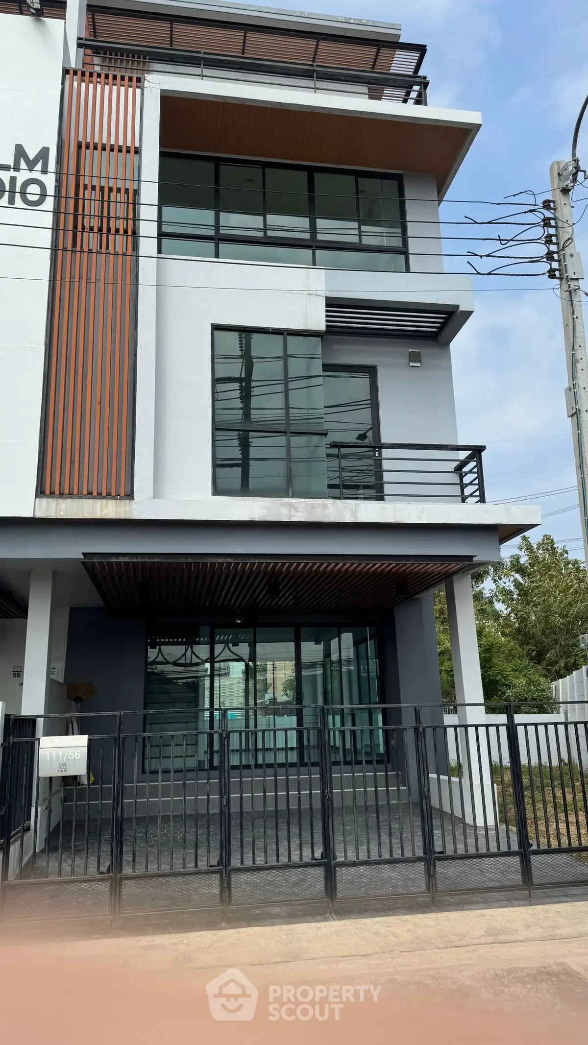 Modern three-story building with sleek design and large windows, perfect for urban living.
