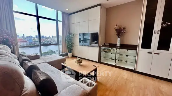 Spacious living room with stunning river view and modern decor