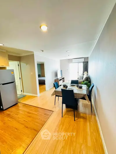 Spacious open-plan living and dining area with modern furnishings and natural light.