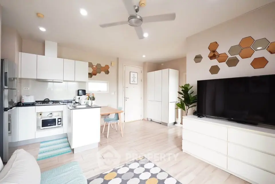 Modern open-plan living room with stylish kitchen and cozy dining area, featuring contemporary decor and ample natural light.