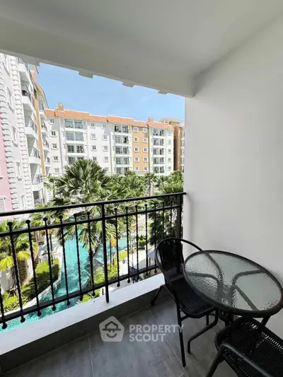 Charming balcony with pool view in modern apartment complex