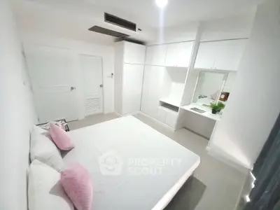 Modern bedroom with white built-in wardrobes and sleek design