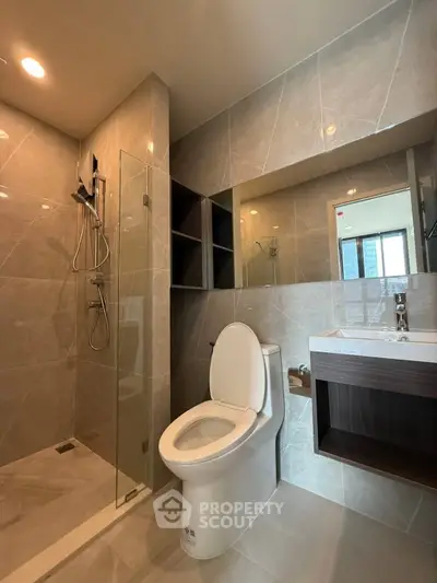 Modern bathroom with sleek shower and elegant fixtures in luxury apartment.