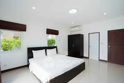 Spacious and bright bedroom with modern furnishings and natural light.