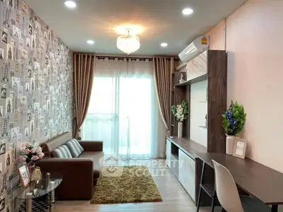 Chic living room with stylish wallpaper, elegant chandelier, and modern furniture in a cozy apartment.