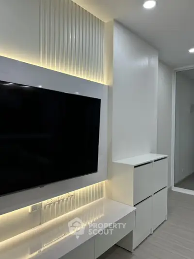 Modern living room with sleek TV setup and ambient lighting