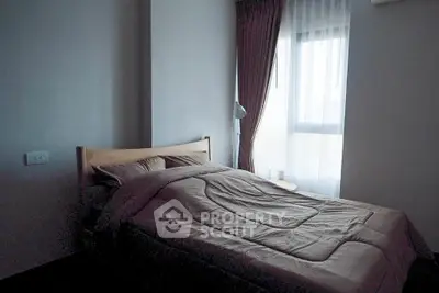 Cozy bedroom with natural light and modern decor in a stylish apartment.