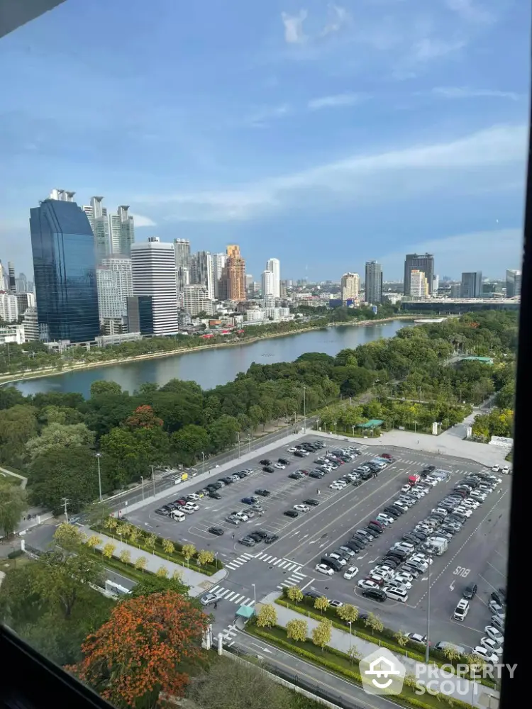 Stunning cityscape view from high-rise building overlooking river and urban skyline.