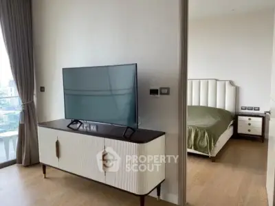 Modern living room with stylish TV stand and glimpse of elegant bedroom