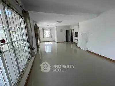 Spacious and bright living room with large windows and modern design.