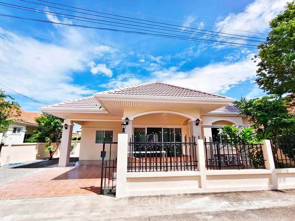 Charming single-story house with tiled roof and spacious front yard in a serene neighborhood.