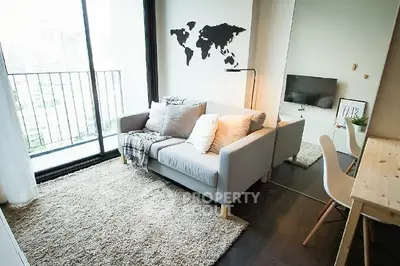 Modern living room with cozy sofa and balcony view in a stylish apartment.
