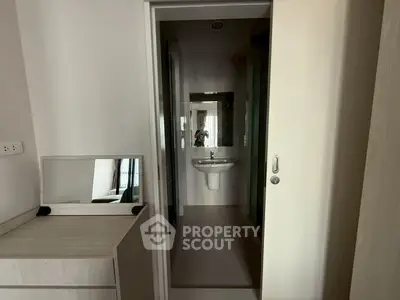 Compact bathroom with modern sink and mirror in minimalist apartment