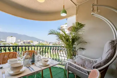 Charming balcony with mountain view, cozy seating, and elegant dining setup, perfect for relaxation and entertaining.
