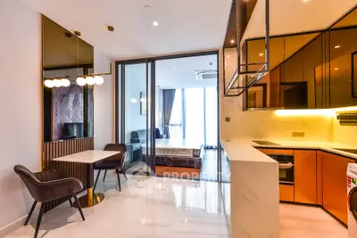 Modern open-plan kitchen and living area with stylish decor and ample natural light
