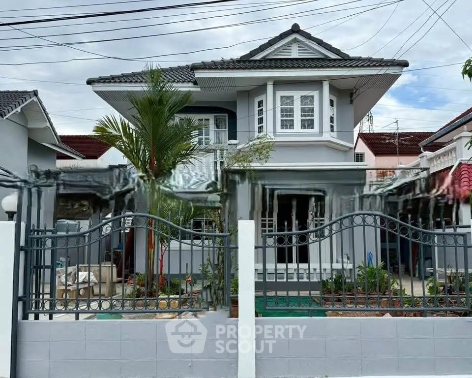 Charming two-story house with modern design and lush garden in a serene neighborhood.