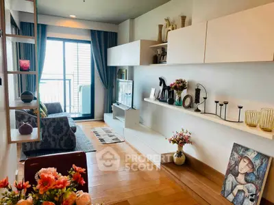 Stylish living room with modern decor and balcony access in a chic apartment.