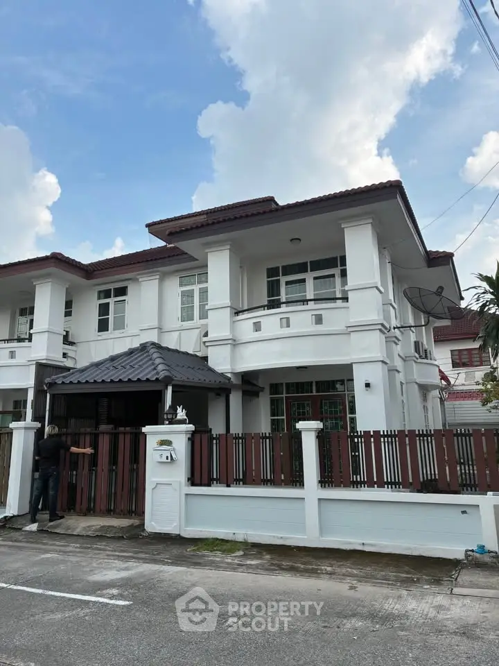 Elegant two-story house with modern architecture and spacious driveway.