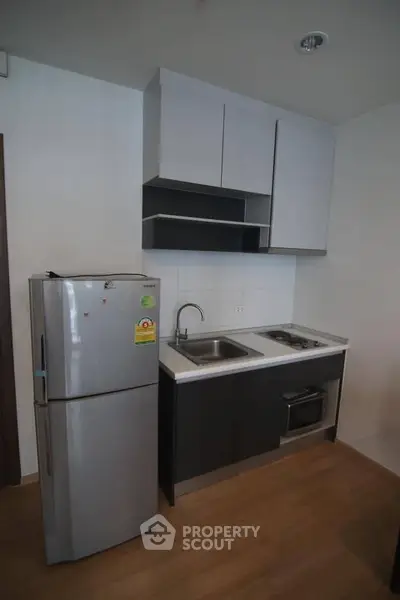 Modern compact kitchen with sleek cabinets and stainless steel appliances