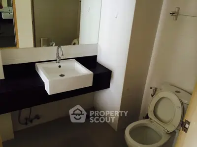 Modern bathroom with sleek sink and toilet in minimalist design
