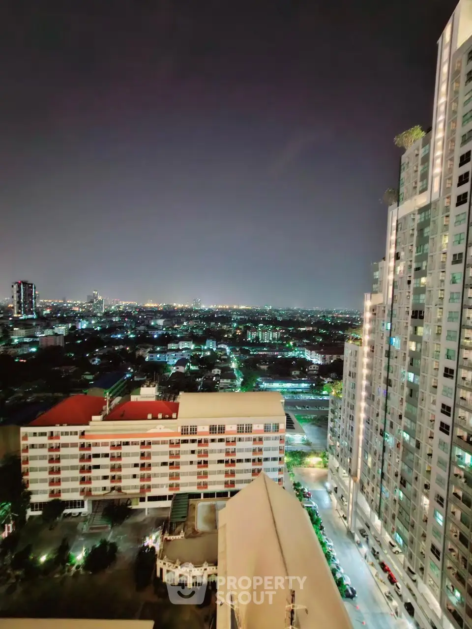 Stunning cityscape night view from high-rise building balcony