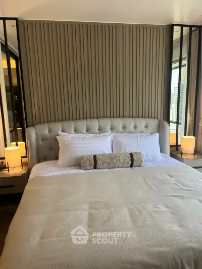 Luxurious bedroom with elegant headboard and ambient lighting in modern apartment.