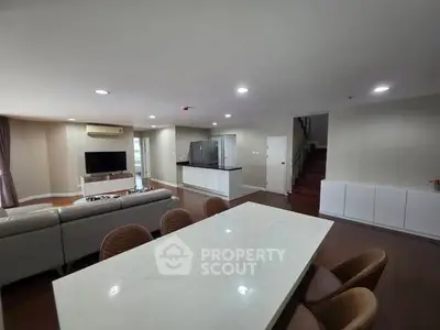 Spacious open-plan living room with modern kitchen and dining area